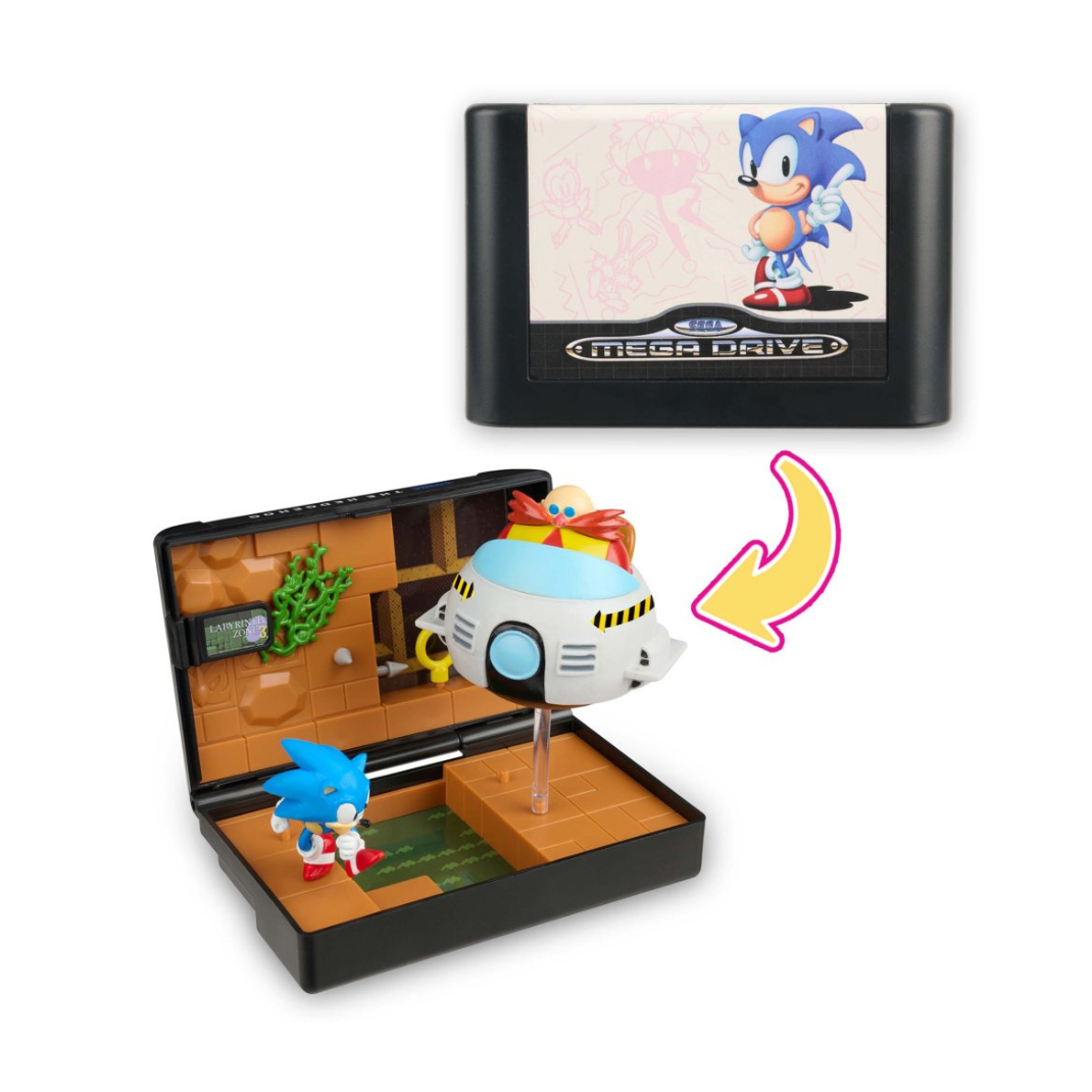 Console Heroes: Sega Mega Drive Display Console Supervillain Boss Bundle, shown open to display the included figures (Mecha Sonic, Mecha Robotnik, Mr. X, Death Bringer) and the exclusive Sonic the Hedgehog 1 diorama cartridge.