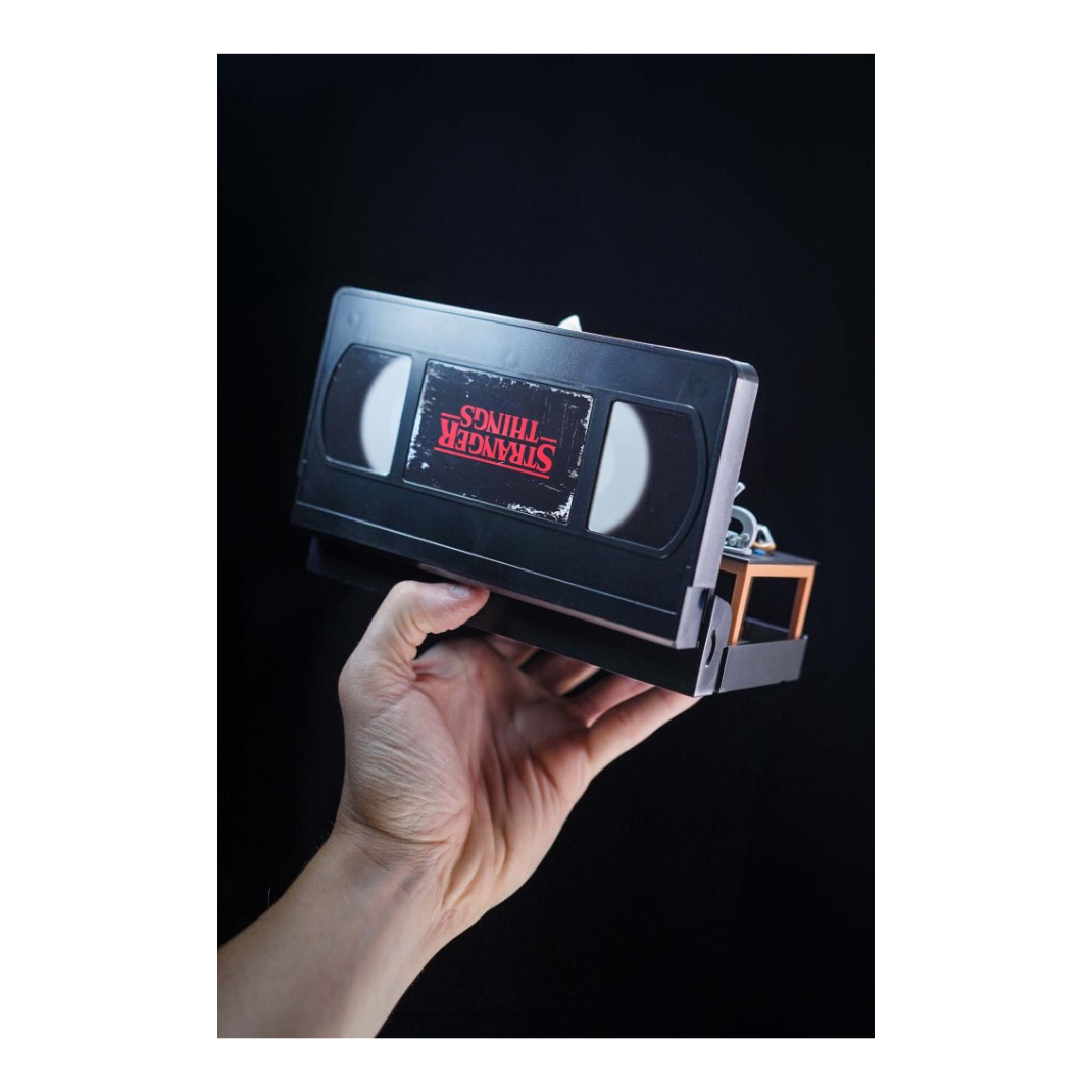 Console Heroes Stranger Things VHS Diorama: Eleven vs. Demogorgon. The collectible is encased in a plastic VHS tape shell, revealing a detailed miniature diorama scene inside the cassette.