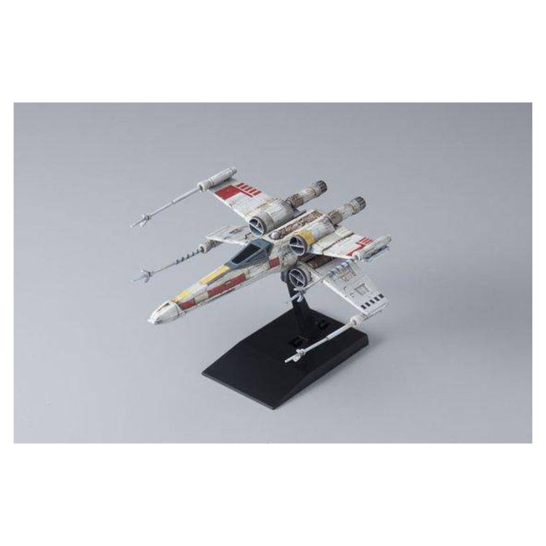 Bandai Star Wars Vehicle Model 002 X-Wing Starfighter plastic model kit, featuring the T-65 starfighter with open S-foils mounted on its black display stand.