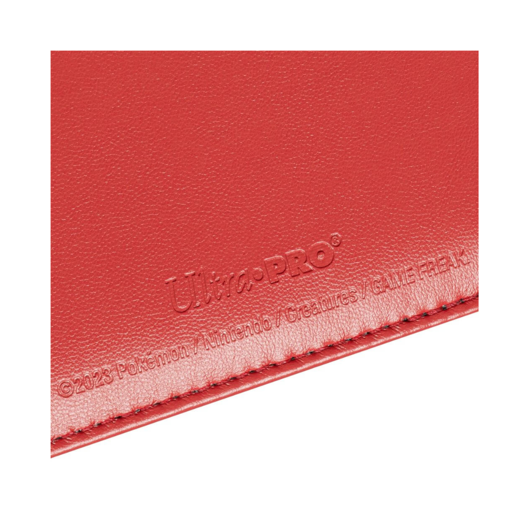 Front view of the Ultra Pro Pokémon Premium Red 4-Pocket Snap Binder showing the red leatherette texture and the enameled Poké Ball snap closure.