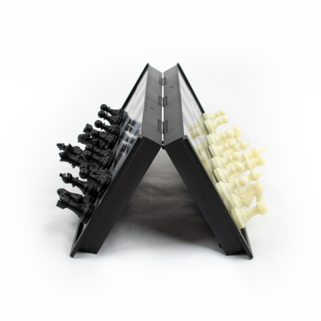A 20cm LPG Classics plastic magnetic travel chess set shown partially folded, revealing the internal storage for the black and white magnetic pieces.