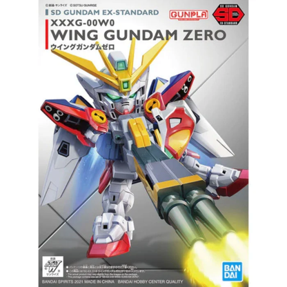 The Bandai SD Gundam EX-Standard Wing Gundam Zero model kit with wings expanded and the Twin Buster Rifle equipped in a firing pose.