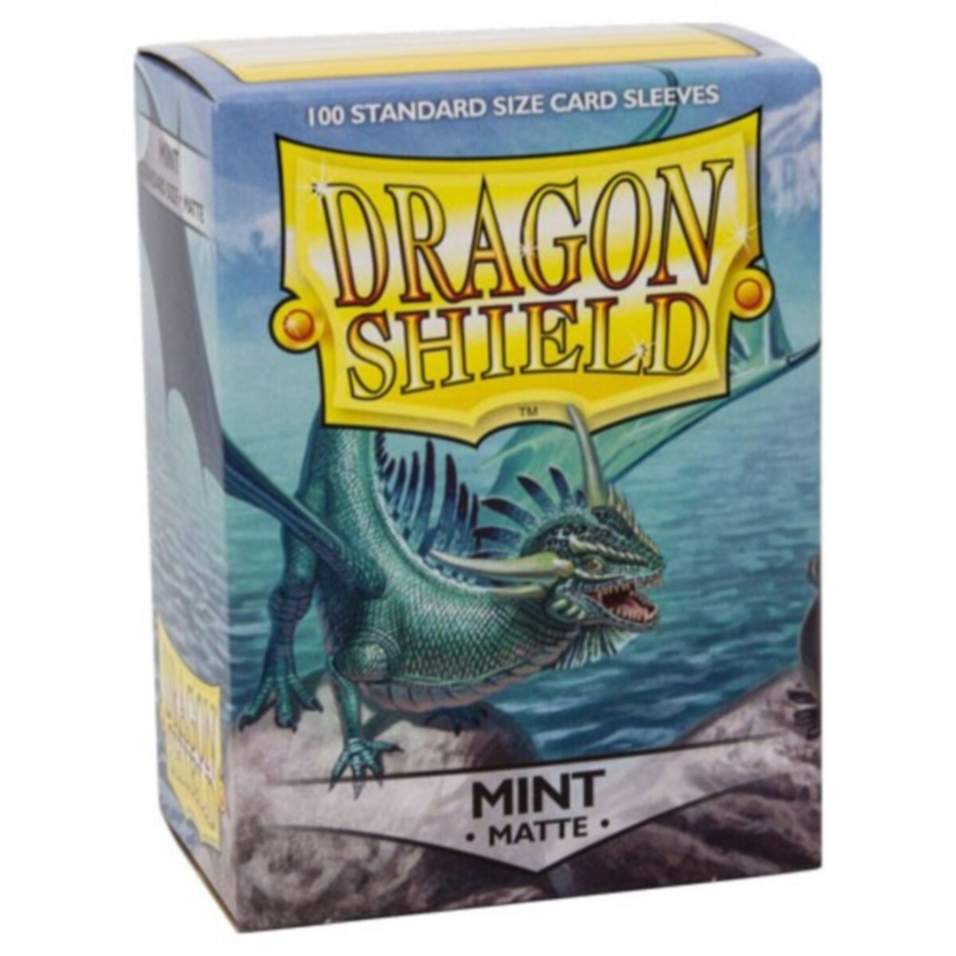A 100-count box of Dragon Shield Mint Matte Sleeves (AT11025) showing the textured mint green back and a standard-size card being sleeved.