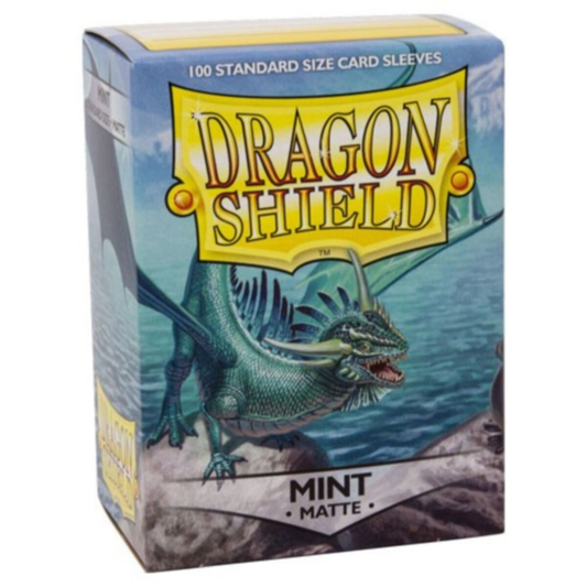 A 100-count box of Dragon Shield Mint Matte Sleeves (AT11025) showing the textured mint green back and a standard-size card being sleeved.