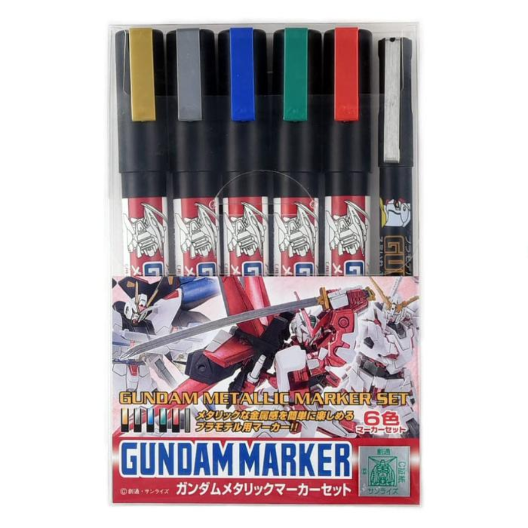 A pack of six Gundam Marker Metallic Set (GMS121) markers including gold, silver, blue, red, green, and a black brush marker.