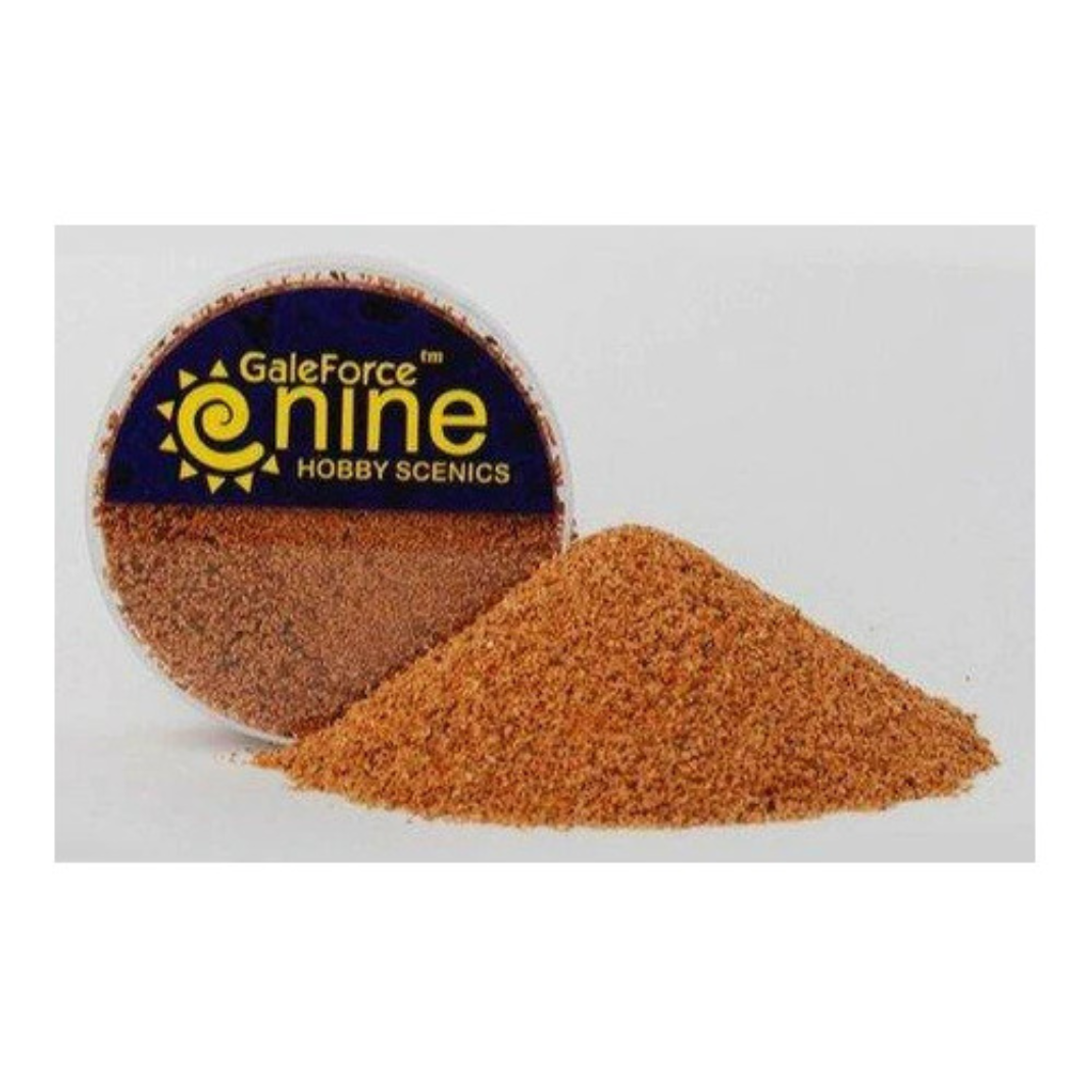 A container of Gale Force Nine Super Fine Basing Grit (GFS018) showing the ultra-fine organic texture used for realistic miniature basing and sand effects.