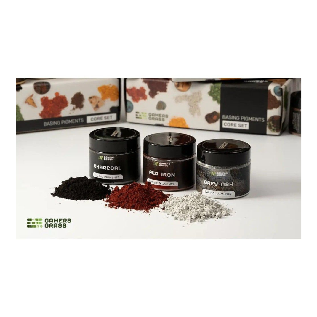 Three jars labeled 'Charcoal', 'Red Iron', and 'Gray Ash' with their respective powders on a white surface, featuring the brand 'Gamer's Grass'.