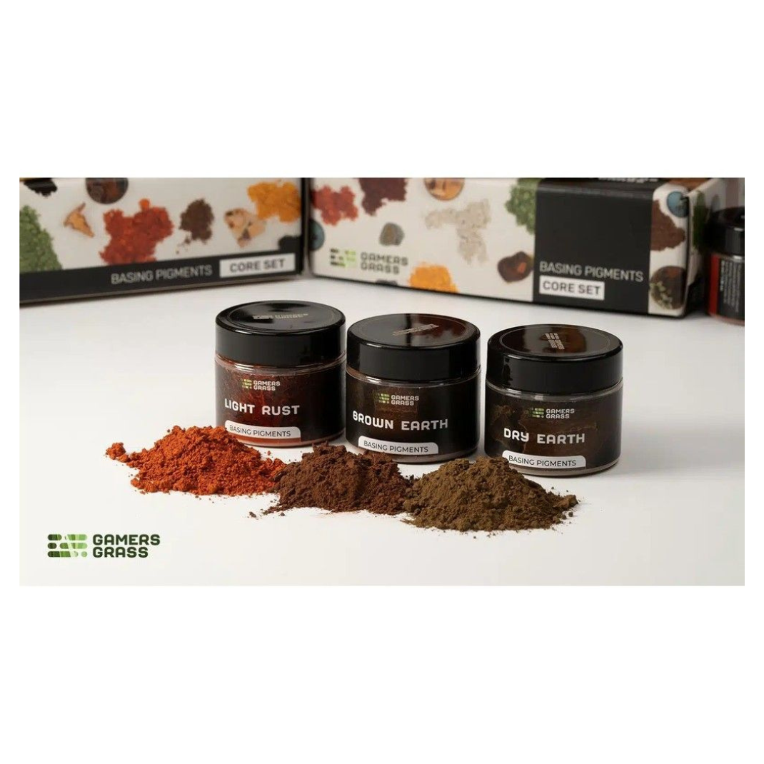 Three small black jars labeled 'Light Rust', 'Brown Earth', and 'Dry Earth' with their contents displayed on a white surface, with 'Gamers Grass' branding visible.