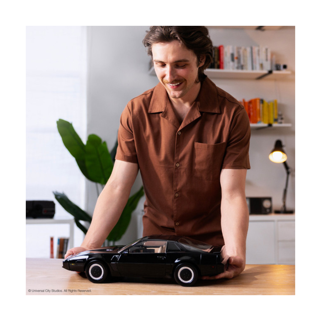 High-quality 1:10 scale replica model of the black Pontiac Trans Am K.I.T.T. from the television show Knight Rider, showing the illuminated red scanner light on the front grille.