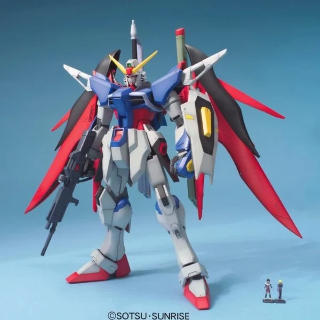 Bandai MG 1/100 Destiny Gundam model kit with included figurines and display stand