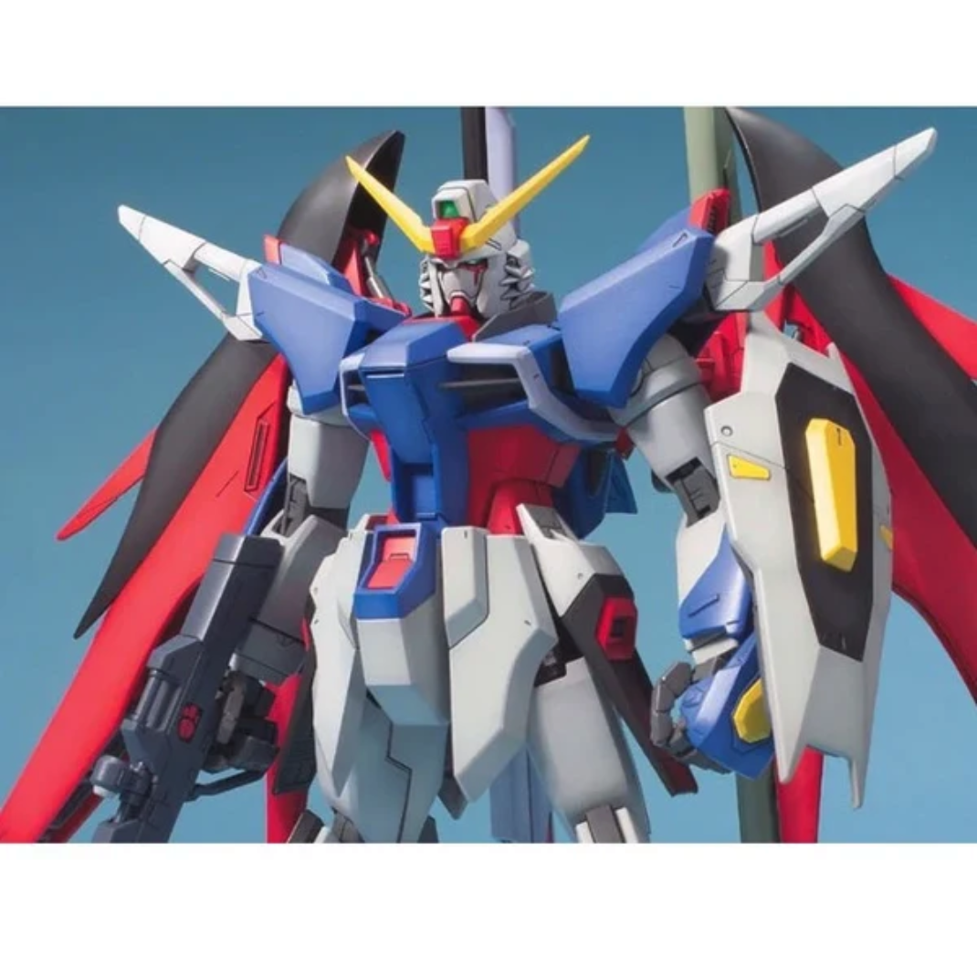 Bandai MG 1/100 Destiny Gundam model kit posed with weapons