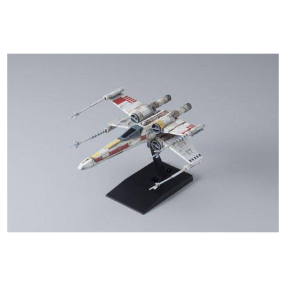 Bandai Star Wars Vehicle Model 002 X-Wing Starfighter plastic model kit, featuring the T-65 starfighter with open S-foils mounted on its black display stand.