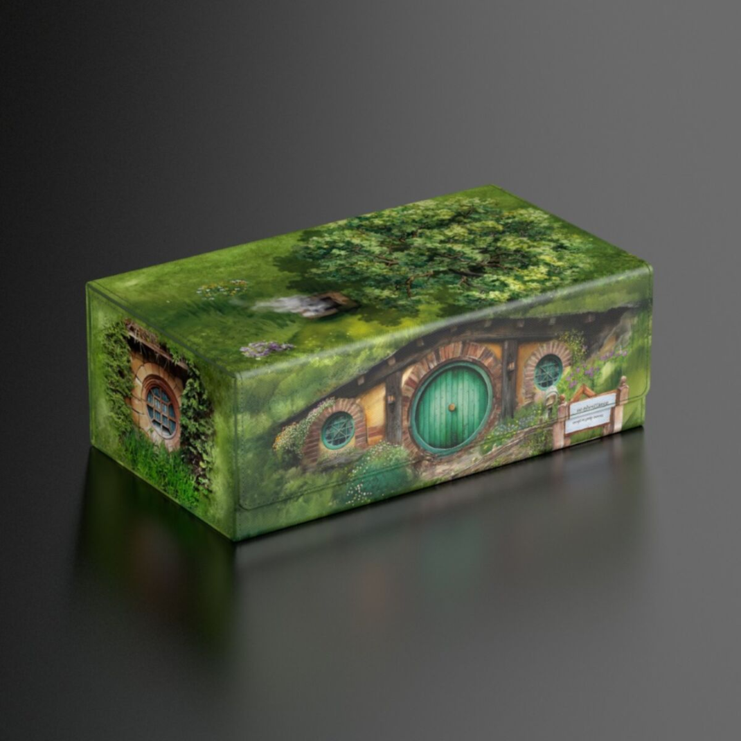 An Ultimate Guard Squaroes Collectors Case featuring the Hobbiton Shire artwork from The Lord of the Rings with a green Xenoskin finish.