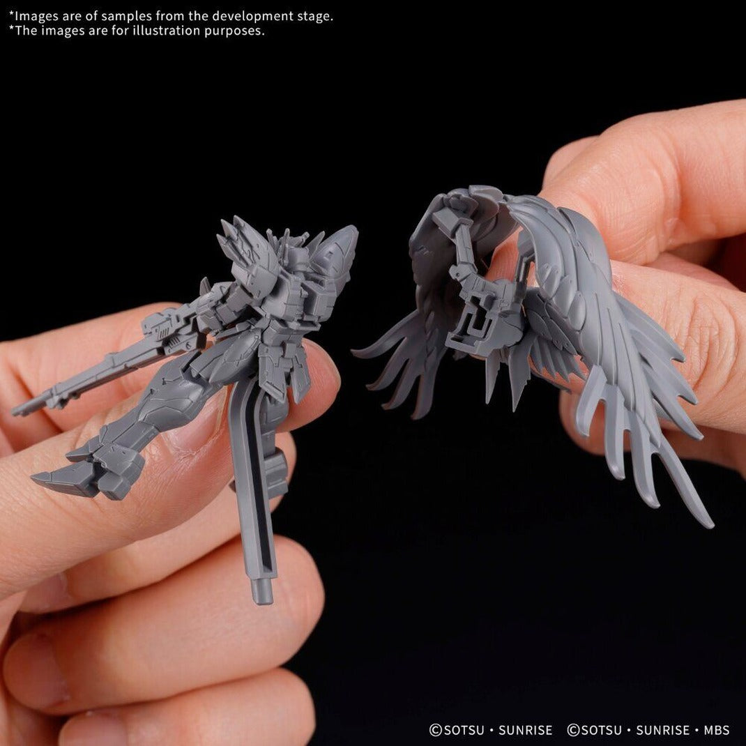 Unpainted grey Gundam Assemble model parts including winged figure and wings held in hand