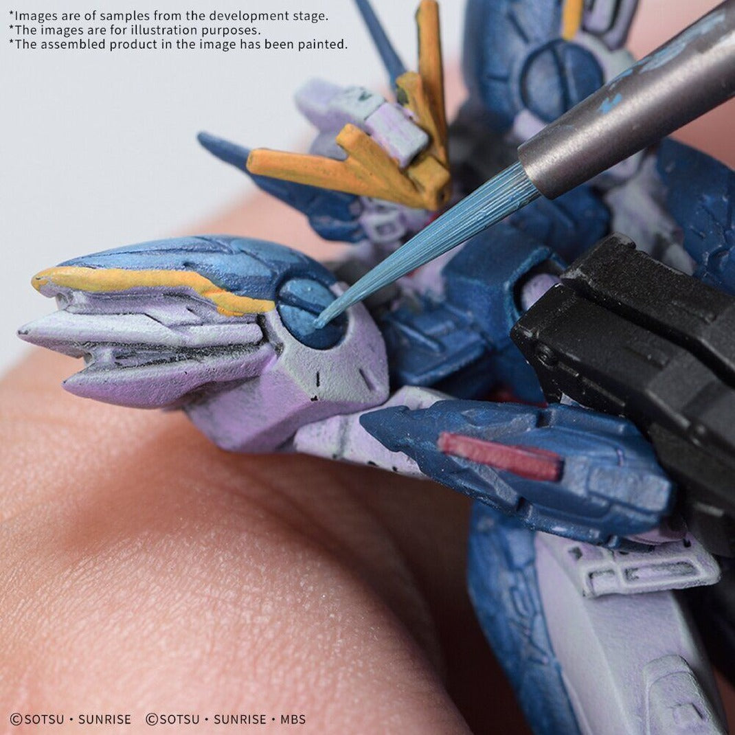 Close-up of a fine brush painting blue and yellow details on a Gundam Assemble figure